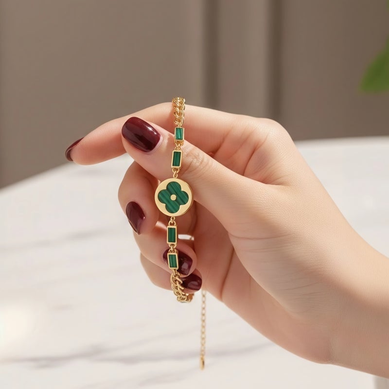 An elegant gold bracelet made of rust-resistant stainless steel, featuring a large, distinctive green flower at its center, adorned with green stones. It has an adjustable clasp for a perfect fit. - Image 4